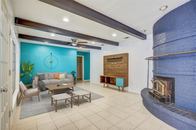 12333 Blue Water Dr, Austin, TX 78758 - living area with ceiling fan, beam ceiling, tile patterned floors, a wood stove, and recessed lighting