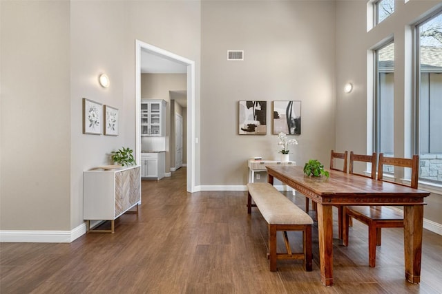 1017 S Quinlan Park Rd, Austin, TX 78732 - dining area with a towering ceiling and dark wood-type flooring