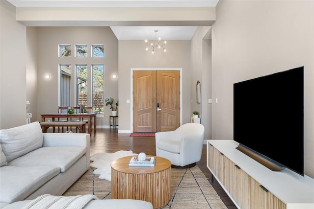 1017 S Quinlan Park Rd, Austin, TX 78732 - living area featuring light wood-style flooring, a high ceiling, and a chandelier
