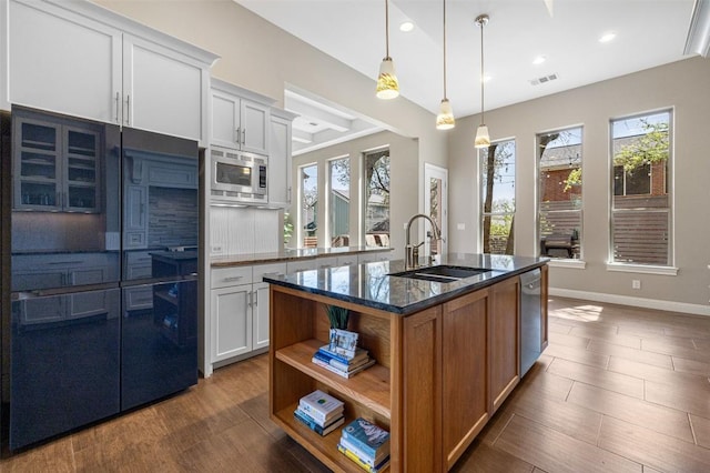 1017 S Quinlan Park Rd, Austin, TX 78732 - kitchen featuring built in appliances, plenty of natural light, dark stone counters, open shelves, and recessed lighting