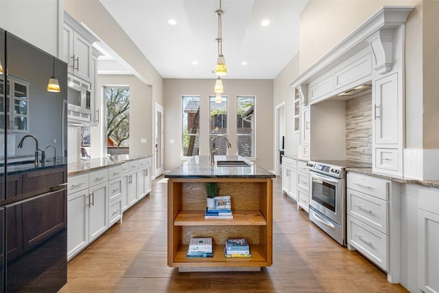 1017 S Quinlan Park Rd, Austin, TX 78732 - kitchen with stainless steel appliances, open shelves, light stone countertops, wood finished floors, and recessed lighting