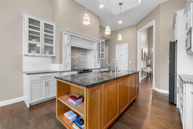 1017 S Quinlan Park Rd, Austin, TX 78732 - kitchen featuring dark wood-style flooring, open shelves, glass insert cabinets, a high ceiling, and tasteful backsplash