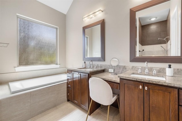 1017 S Quinlan Park Rd, Austin, TX 78732 - full bath featuring two vanities, tiled bath, a tile shower, vaulted ceiling, and tile patterned flooring