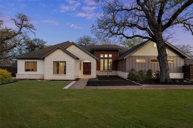 1017 S Quinlan Park Rd, Austin, TX 78732 - view of front of property featuring board and batten siding, stone siding, a lawn, and a shingled roof