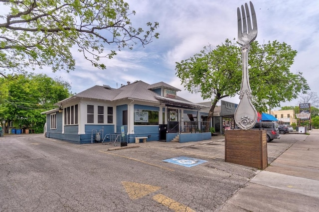 611 E 45th St Unit 15, Austin, TX 78751 - view of front of home featuring uncovered parking and roof with shingles