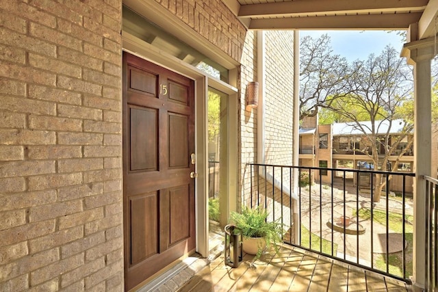 611 E 45th St Unit 15, Austin, TX 78751 - view of exterior entry with brick siding and a balcony