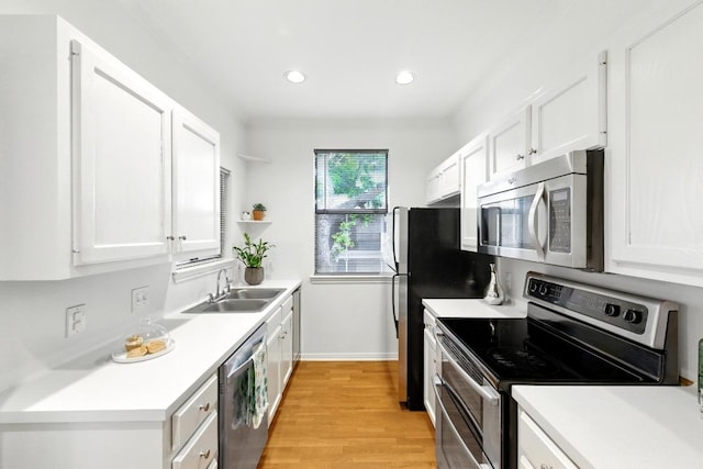 611 E 45th St Unit 15, Austin, TX 78751 - kitchen with stainless steel appliances, open shelves, white cabinets, light wood-style floors, and light countertops