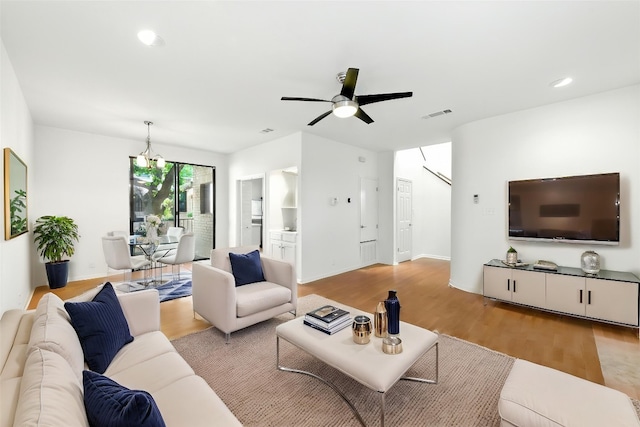 611 E 45th St Unit 15, Austin, TX 78751 - living room with light wood finished floors, a chandelier, ceiling fan, and recessed lighting