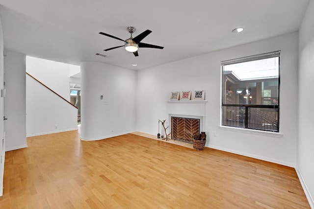 611 E 45th St Unit 15, Austin, TX 78751 - unfurnished living room with a fireplace with flush hearth, plenty of natural light, light wood-style flooring, and recessed lighting