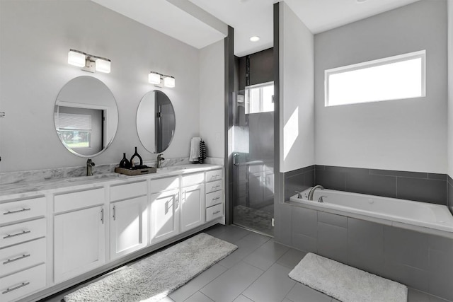 22113 Shotts Dr, Spicewood, TX 78669 - bathroom featuring double vanity, a bath, a shower stall, and tile patterned floors