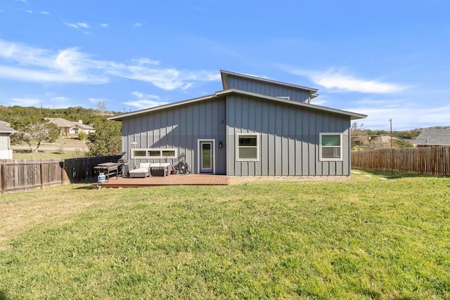 22113 Shotts Dr, Spicewood, TX 78669 - back of property featuring board and batten siding, a wooden deck, and an outdoor living space