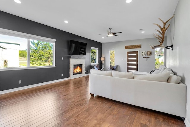 22113 Shotts Dr, Spicewood, TX 78669 - living area featuring a stone fireplace, recessed lighting, dark wood finished floors, baseboards, and a ceiling fan