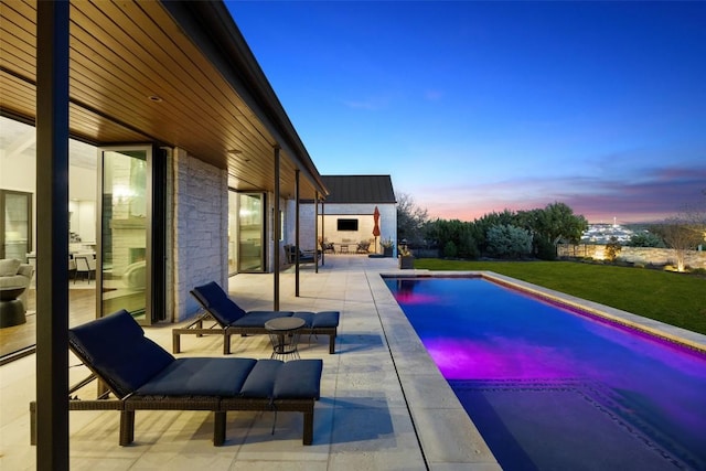 599 Vendemmia Bnd, Austin, TX 78738 - pool at dusk featuring a patio area, an outdoor pool, a yard, and an outbuilding