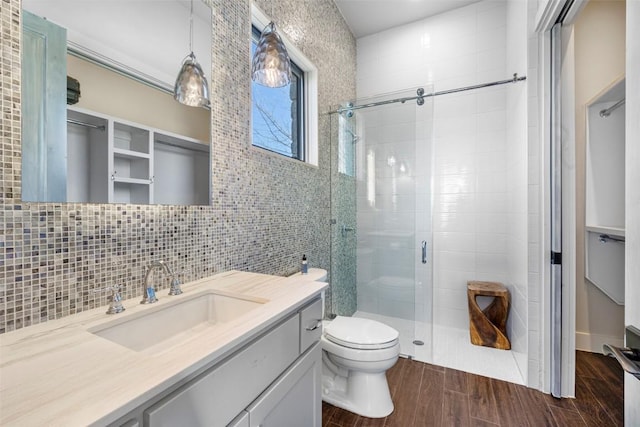 599 Vendemmia Bnd, Austin, TX 78738 - full bath featuring a stall shower, vanity, wood finished floors, a walk in closet, and tile walls