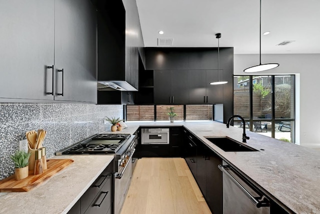 2109 Glendale Pl, Austin, TX 78704 - kitchen featuring appliances with stainless steel finishes, a sink, dark cabinetry, modern cabinets, and recessed lighting