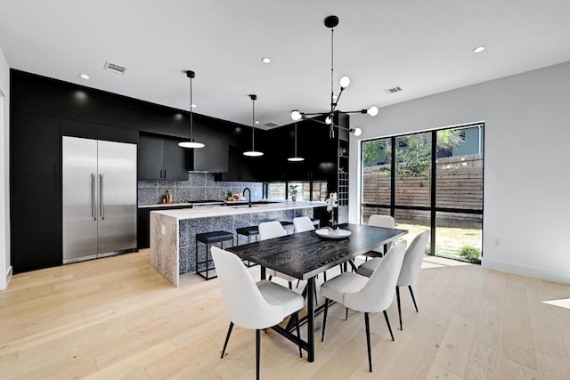 2109 Glendale Pl, Austin, TX 78704 - dining space with light wood-style flooring, recessed lighting, and a chandelier