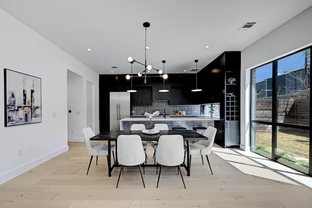 2109 Glendale Pl, Austin, TX 78704 - kitchen with dark cabinetry, built in fridge, tasteful backsplash, light wood-style flooring, and recessed lighting