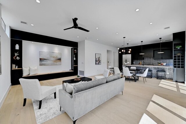 2109 Glendale Pl, Austin, TX 78704 - living room featuring light wood-type flooring, recessed lighting, ceiling fan, and baseboards