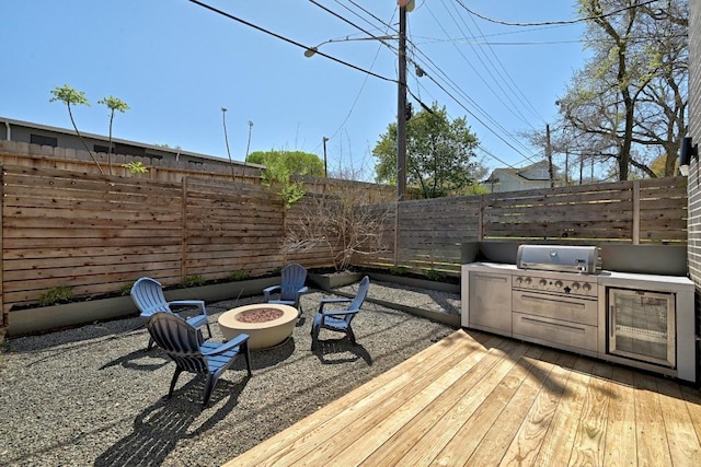2109 Glendale Pl, Austin, TX 78704 - wooden deck featuring a fenced backyard, an outdoor fire pit, and area for grilling