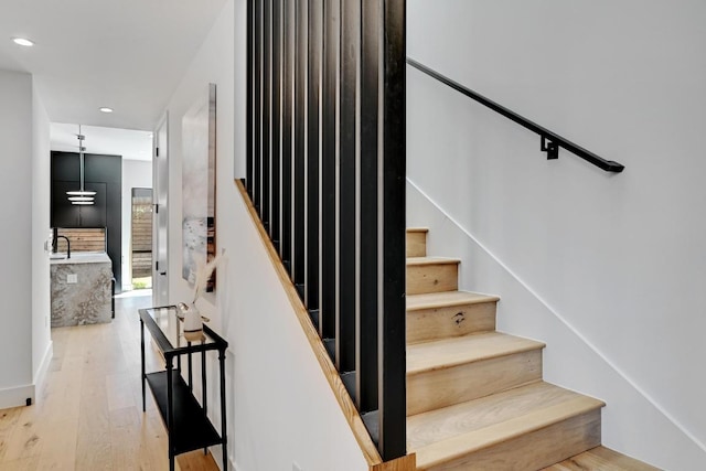 2109 Glendale Pl, Austin, TX 78704 - stairway with wood finished floors and recessed lighting