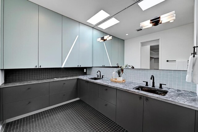 2109 Glendale Pl, Austin, TX 78704 - kitchen featuring a sink, gray cabinetry, and backsplash