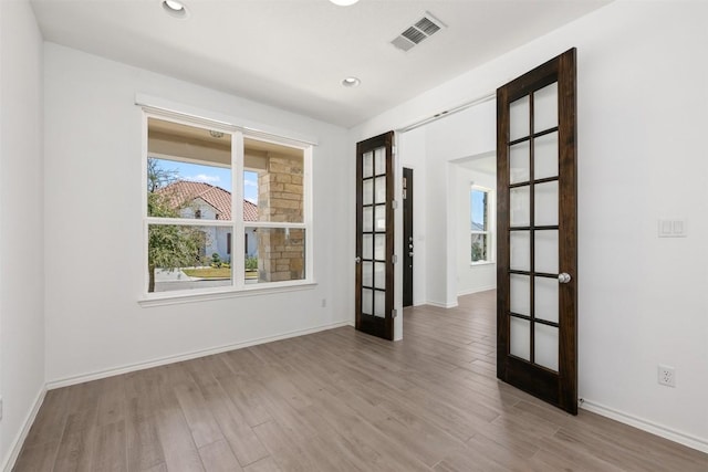 19604 Summit Glory Trl, Spicewood, TX 78669 - empty room with french doors, wood finished floors, and recessed lighting