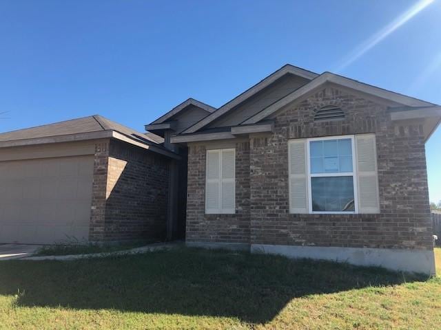 320 Gettysburg Loop, Elgin, TX 78621 - ranch-style house with a garage, brick siding, and a front yard