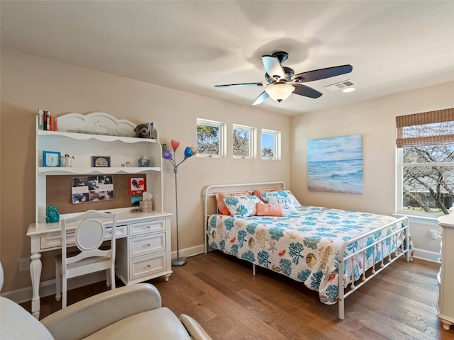 300 E Heron Dr, Marble Falls, TX 78654 - bedroom featuring multiple windows, wood finished floors, and baseboards