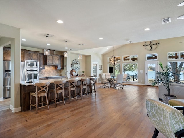 300 E Heron Dr, Marble Falls, TX 78654 - kitchen with appliances with stainless steel finishes, open floor plan, a kitchen bar, and recessed lighting