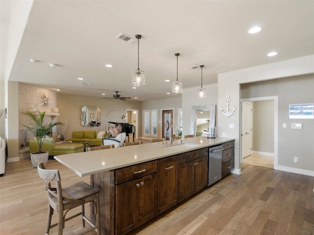 300 E Heron Dr, Marble Falls, TX 78654 - kitchen with a sink, stainless steel dishwasher, light countertops, ceiling fan, and light wood finished floors
