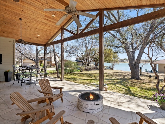 300 E Heron Dr, Marble Falls, TX 78654 - view of patio with an outdoor fire pit, a ceiling fan, outdoor dining area, and a water view