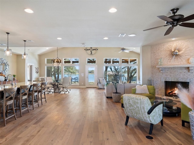 300 E Heron Dr, Marble Falls, TX 78654 - living room featuring a ceiling fan, wood-type flooring, a fireplace, recessed lighting, and vaulted ceiling