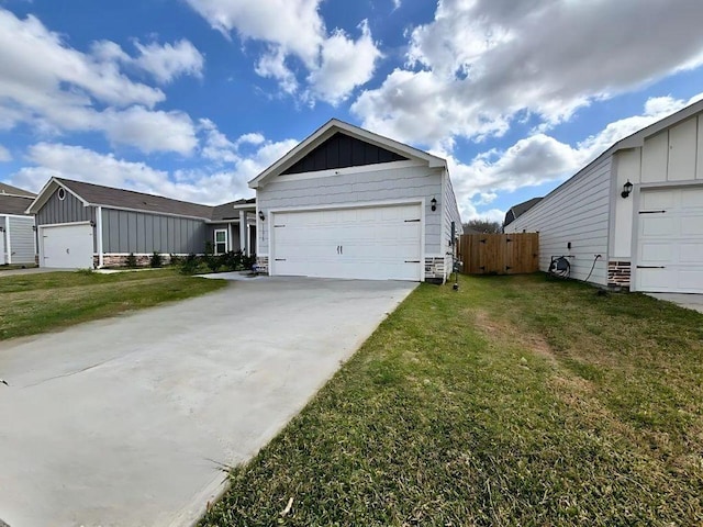view of property exterior with fence, a yard, concrete driveway, a garage, and board and batten siding