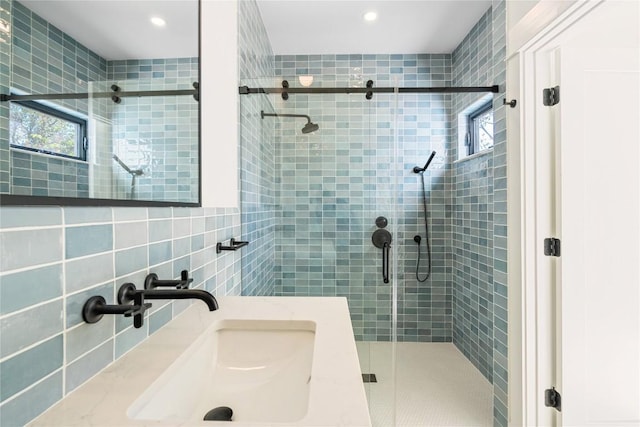 717 Meriden Ln, Austin, TX 78703 - bathroom featuring a sink, tile walls, a stall shower, and recessed lighting