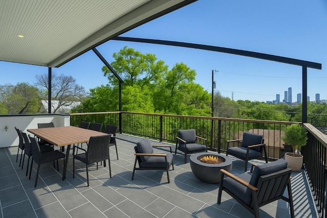 view of patio / terrace with outdoor dining area and an outdoor living space with a fire pit