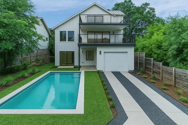 717 Meriden Ln, Austin, TX 78703 - rear view of property with a balcony, board and batten siding, a fenced backyard, and driveway