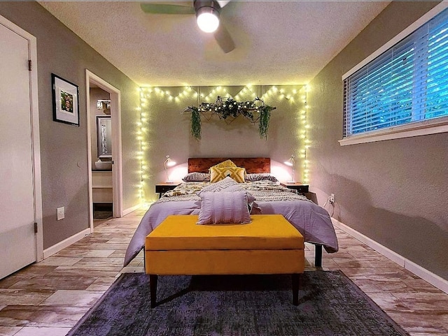 bedroom featuring a textured ceiling, baseboards, a ceiling fan, and wood finished floors