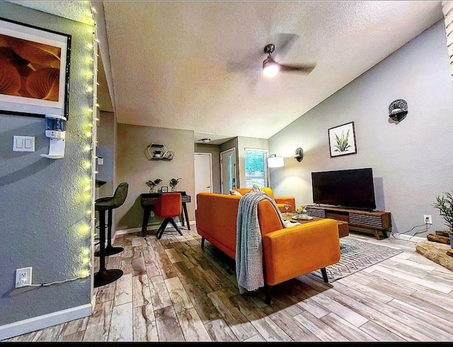 11815 Lochridge Dr, Austin, TX 78758 - living room featuring vaulted ceiling, wood finished floors, a textured ceiling, a ceiling fan, and baseboards