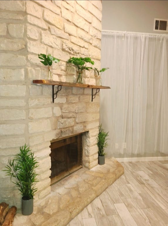 interior details featuring a stone fireplace and visible vents