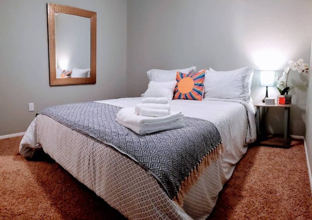 bedroom with baseboards and carpet floors