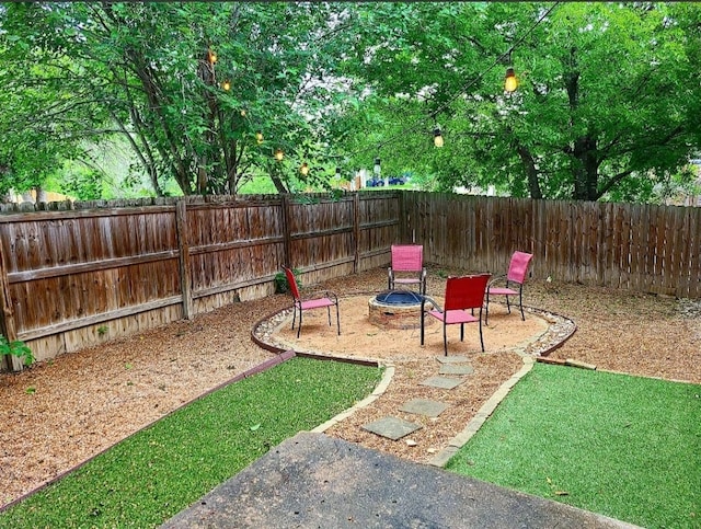 view of yard featuring a patio, a fire pit, and a fenced backyard