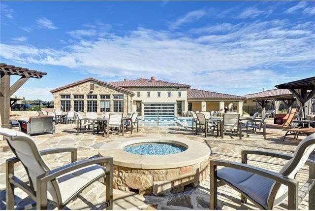 104 Bella Toscana Ave Unit 2301, Lakeway, TX 78734 - view of patio / terrace featuring a gazebo, a community pool, and outdoor dining area