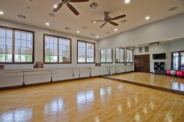 104 Bella Toscana Ave Unit 2301, Lakeway, TX 78734 - workout room featuring a ceiling fan, wood finished floors, recessed lighting, and a glass covered fireplace