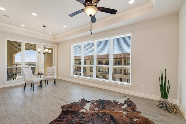 104 Bella Toscana Ave Unit 2301, Lakeway, TX 78734 - living area with a tray ceiling, ornamental molding, a chandelier, light wood-style floors, and baseboards