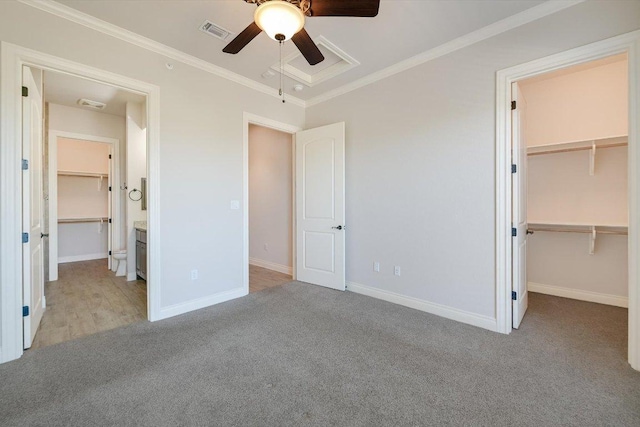 104 Bella Toscana Ave Unit 2301, Lakeway, TX 78734 - unfurnished bedroom featuring a walk in closet, light colored carpet, ornamental molding, a closet, and baseboards