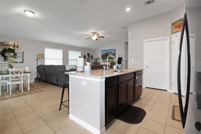 180 Sunshine Ln, Kyle, TX 78640 - kitchen with a ceiling fan, light tile patterned flooring, open floor plan, a kitchen breakfast bar, and dishwashing machine