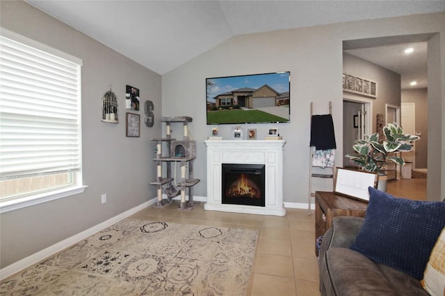 180 Sunshine Ln, Kyle, TX 78640 - living room with baseboards, a lit fireplace, light tile patterned floors, and vaulted ceiling