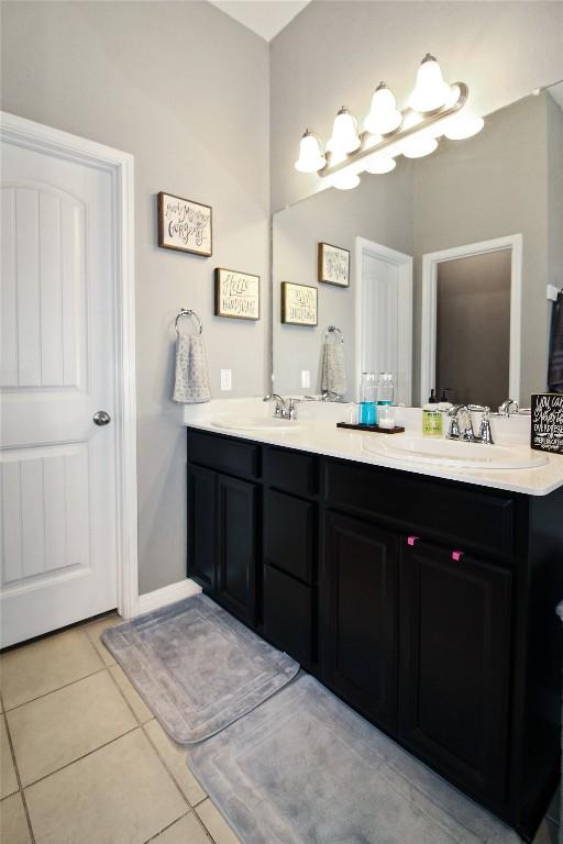 180 Sunshine Ln, Kyle, TX 78640 - full bathroom with double vanity, a sink, and tile patterned floors