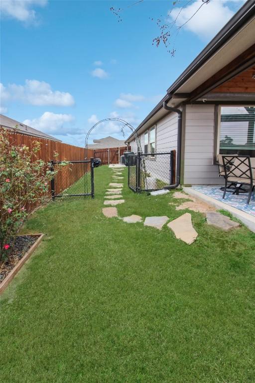 180 Sunshine Ln, Kyle, TX 78640 - view of yard with a fenced backyard and a patio area