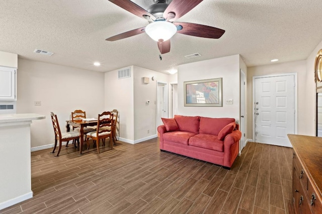 9226 Jollyville Rd Unit 170, Austin, TX 78759 - living area featuring baseboards, dark wood-style floors, a textured ceiling, a ceiling fan, and recessed lighting